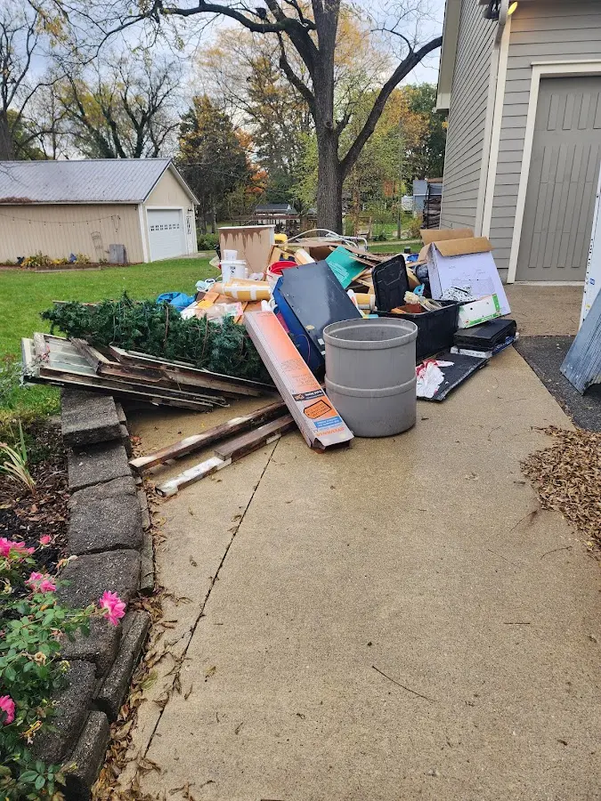 Dumpster being loaded with debris for Commercial Dumpster Rental in Windham